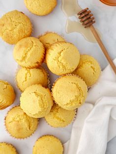 a bunch of muffins sitting on top of a table next to a fork