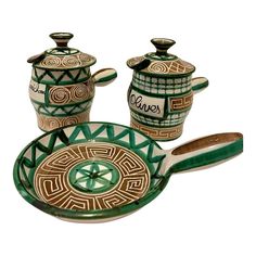 three pieces of green and white pottery with designs on them, including two serving dishes