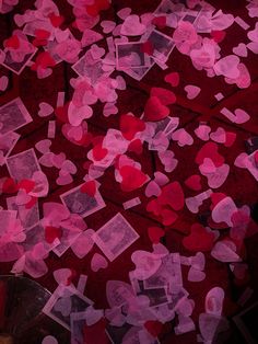 many hearts are scattered on the ground in pink and red colors as if they were made out of tissue paper