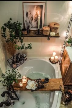 a bathtub with candles and plants in it