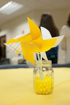 a jar filled with yellow candy sitting on top of a table