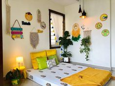 a bed room with a neatly made bed and hanging plants