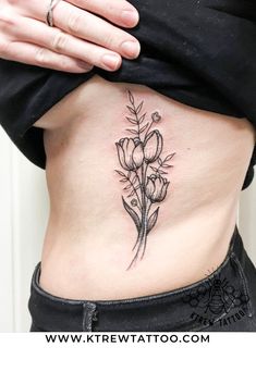 a woman with a flower tattoo on her stomach