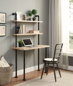 a desk with a laptop on it in front of a window and a chair next to it