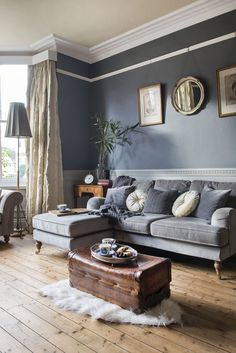 a living room with blue walls and wooden floors