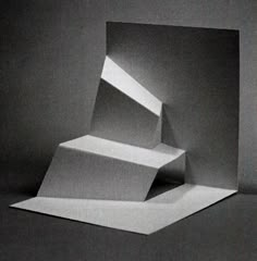 an image of three white boxes stacked on top of each other in black and white