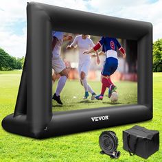 an inflatable tv screen sitting on top of a field next to a charger