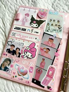 a pink binder with pictures and stickers on it