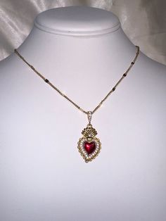 A beautiful 14k gold and red enamel sacred heart necklace on a 14k gold filled curb chain. Featuring cubic zirconia pave detailing on the pendant. Chain length: 17.5 Inch Red Heart Charm Fine Jewelry, Red Fine Jewelry With Heart Charm, Red 14k Gold Jewelry For Valentine's Day, Red 14k Gold Heart Cut Jewelry, 14k Gold Heart Cut Red Jewelry, Gold Heart Pendant Necklace With Jewels, Red Heart Pendant Necklace In 14k Gold, Red 14k Gold Heart Pendant Necklace, Red 14k Gold Necklace For Valentine's Day