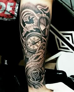 a man's arm with a clock and roses tattoo on it