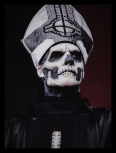 a skeleton wearing a hat and black shirt with white paint on it's face