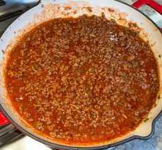 a large pot filled with chili sauce on top of a stove