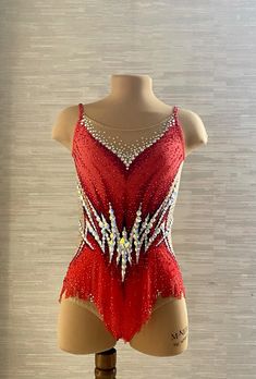 a woman's red and white leotard with sequins on it