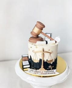 a cake with a judge's gavel on top and other items around it