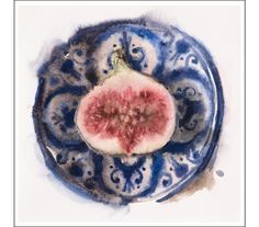 a blue and white plate with a piece of fruit in it's center, on a white background