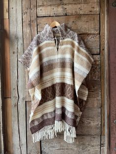 Brown wool poncho Alpaca/lambswool mix poncho Beige wool poncho very warm and breathable Ethno style Blanket poncho with fringes alpaca wool One size fits fashionably for most everyone, short or tall, big or small. This piece is versatile for both Men's & Women's outdoor fashion, and can be used insider in cooler winter weather to keep warm while reading on the couch. CARE: Hand-wash and hang to dry, light iron if needed, or dry clean. MEASURES: Length at the front of the neckline to the bottom Brown Alpaca Poncho For Winter, Bohemian Alpaca Cape For Fall, Cozy Brown Alpaca Poncho, Brown Wool Bohemian Shawl, Bohemian Alpaca Shawl For Fall, Cozy Brown Wool Poncho, Handwoven Wool Poncho For Fall, Handwoven Alpaca Poncho For Fall, Fall Handwoven Alpaca Poncho