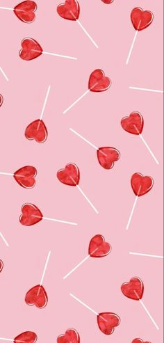 red hearts and lollipops are on a pink background with white lines in the middle