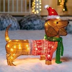 a lighted dachshund dog standing in the snow