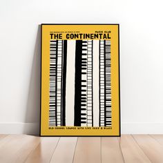 a yellow poster with black and white piano keys on the front, against a white wall