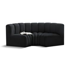 a large black couch sitting on top of a white floor