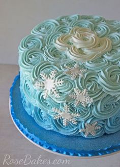 a blue and white frosted cake with snowflakes on it