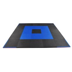 a blue and black mat with squares on it, in front of a white background