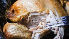 a close up of a turkey in a plastic bag with a fork