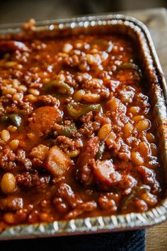 a metal pan filled with chili and beans