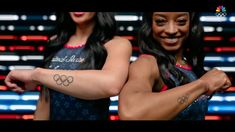 two women with tattoos on their arms are posing for the olympic team photobombs