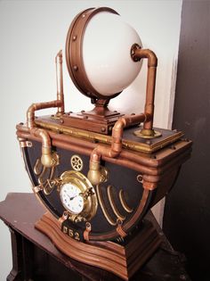 an antique clock with pipes and a globe on top