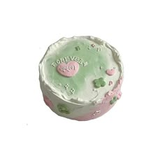 a green and pink cake with hearts on it