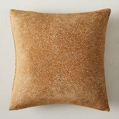 a brown pillow with white spots on it