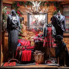 an image of a christmas display in a store window with clothes and decorations on the windowsill