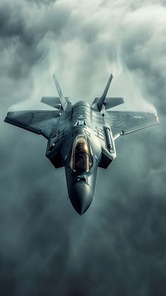 a fighter jet flying through a cloudy sky