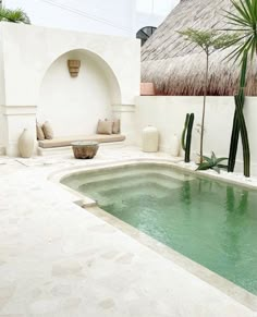 an outdoor swimming pool in the middle of a courtyard