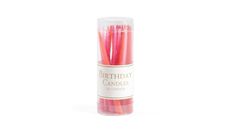 pink birthday candles in a tube on a white background