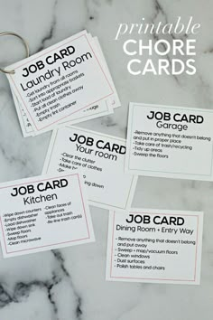 four business cards with the words job card and name tags attached to them on a marble surface