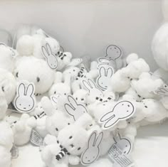 a pile of white stuffed animals sitting next to each other