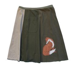 "Classic Appliqué skirts are made with high quality, up-cycled t-shirts. Freestyle sewn images are appliquéd on panels of various colors making each skirt unique and interesting.  Each skirt has a convenient pocket. Since there is no real \"front\" or \"back\"of this skirt, simply place the pocket where you like. The 21\" length, a-line cut, elastic waist and up-cycled knit fabric create an ultra comfortable skirt that will be your best friend all year long. EACH SKIRT IS MADE TO ORDER AND UNIQU Cotton Patchwork Mini Skirt, Casual Reworked Skirt For Summer, Casual Reworked Summer Skirt, Fitted Cotton Patchwork Skirt, Retro Cotton Patchwork Skirt, Fitted Cotton Skirt With Reworked Details, Spring Cotton Skirt Upcycled, Casual Upcycled Denim Skirt, Upcycled Cotton Summer Skirt