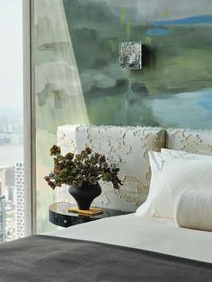 a bedroom with a large painting on the wall