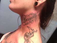 a woman with a bird tattoo on her neck