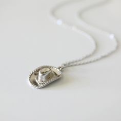 Beautiful and lovely cowboy/ cowgirl hat necklace in silver color. Made of matte finished cowboy/cowgirl hat pendant with skinny rhodium plated brass chain. A soft and warm necklace is good for every day or gift. Your necklace will ship in a gift box.  ♥Chain length 14" - 20" ♥Cowboy/cowgirl hat pendant  5/8" x 7/8" ♥Rhodium plated over brass chain ♥ Delivery Time Fast shipping within 1 - 3 days  ♥  See more Rudiana Accessories  Rudiana.etsy.com Chapeau Cowboy, Cowgirl Hat, Cowboy Cowgirl, Cowgirl Hats, Cow Girl, Cow Boy, Cowboy And Cowgirl, Cowboy Hat, Brass Chain