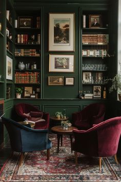 two chairs and a table in a room with bookshelves