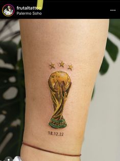 a woman's leg with a tattoo of the world cup on her left side