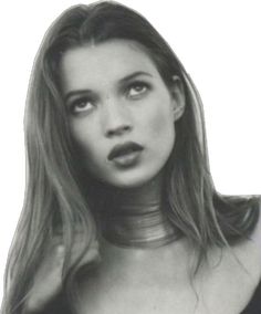 a black and white photo of a woman with long hair wearing a choker around her neck