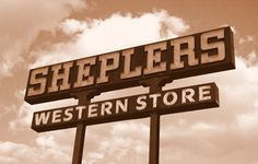 a sign that says shepherds western store under a cloudy sky