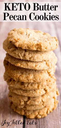 a stack of keto butter pecan cookies sitting on top of a wooden table