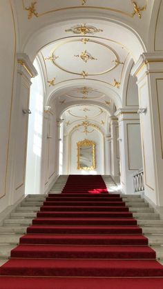 red carpeted stairs leading up to an ornate white building