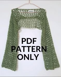 a green knitted shawl hanging on a white wall with the text free pattern only