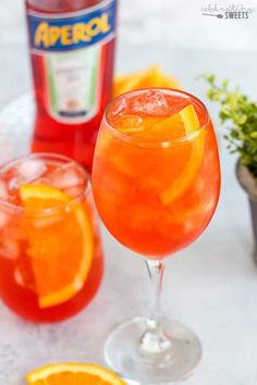 the best apricot spritz is in a glass with an orange slice